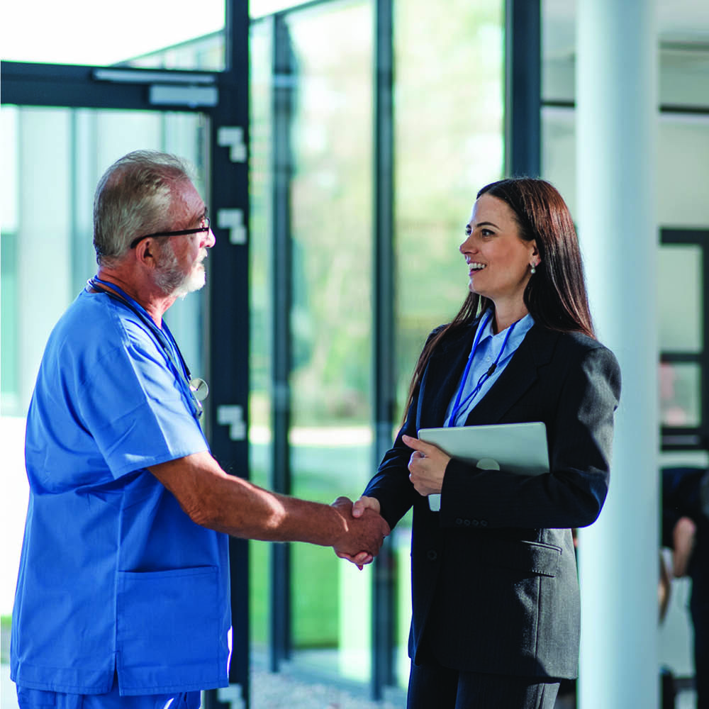 Doctor shaking hands with businesswoman