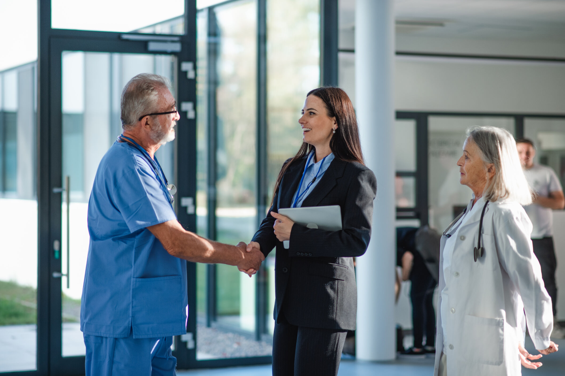 Health Venture Office manager shakes hands with doctor in hospital